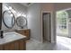 Bright bathroom features double sinks, round mirrors and marble countertops at 123 Wildwood Dr, Temple, GA 30179