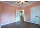 Neutral bedroom with crown molding, wood-look tile flooring, and view to hallway at 123 Wildwood Dr, Temple, GA 30179