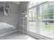 Walk-in closet area featuring built in shelving and a large arched window at 123 Wildwood Dr, Temple, GA 30179