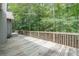 Large wooden deck with railing overlooking wooded backyard at 123 Wildwood Dr, Temple, GA 30179