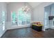 Dining area with large windows, chandelier, and view of wooded backyard at 123 Wildwood Dr, Temple, GA 30179