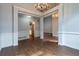 Spacious dining room featuring hardwood floors, elegant chandeliers, and white column accents at 123 Wildwood Dr, Temple, GA 30179