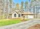 Charming single-Gathering home with stone accents, manicured lawn, and a convenient two-car attached garage at 123 Wildwood Dr, Temple, GA 30179