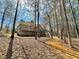 Back of house with wooded backyard and a long deck at 123 Wildwood Dr, Temple, GA 30179