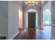 Elegant foyer with gleaming hardwood floors, a decorative chandelier, and large windows letting in ample light at 123 Wildwood Dr, Temple, GA 30179