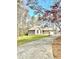 Inviting home exterior with stone accents, well-manicured lawn, and a spacious driveway leading to an attached garage at 123 Wildwood Dr, Temple, GA 30179