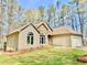 Charming single-Gathering home featuring stone accents, well-maintained landscaping, and an attached two car garage at 123 Wildwood Dr, Temple, GA 30179
