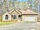 Inviting single-Gathering home with stone and vinyl siding, a two car garage, and a well manicured lawn at 123 Wildwood Dr, Temple, GA 30179