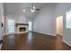 Inviting living room showcasing a stone fireplace, a vaulted ceiling, and hardwood floors at 123 Wildwood Dr, Temple, GA 30179
