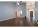 Spacious living room with hardwood floors and a view of the foyer, front door, and an adjacent bedroom at 123 Wildwood Dr, Temple, GA 30179