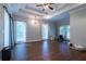 Spacious living room with tray ceilings, wood-look tile flooring, and windows to the backyard at 123 Wildwood Dr, Temple, GA 30179