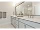 Bright bathroom featuring a double sink vanity with modern fixtures and a large mirror at 125 Sidney St, Marietta, GA 30060