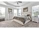 Cozy bedroom featuring a large bed, tray ceiling, and an abundance of natural light at 125 Sidney St, Marietta, GA 30060