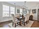 Inviting dining room featuring hardwood floors, a stylish light fixture, and plenty of natural light from large windows at 125 Sidney St, Marietta, GA 30060