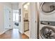 Hallway with hardwood floors and a view of the laundry and bedroom at 125 Sidney St, Marietta, GA 30060