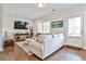 Bright living room featuring hardwood floors, a plush sofa, and a door to the outdoors, creating a welcoming atmosphere at 125 Sidney St, Marietta, GA 30060