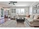Bright living room features a large sectional sofa, ceiling fan, and opens to a screened porch at 125 Sidney St, Marietta, GA 30060
