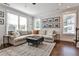 Comfortable living room features hardwood floors, a cozy sectional sofa, and large windows, offering a relaxing living space at 125 Sidney St, Marietta, GA 30060