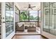 Relaxing screened porch featuring comfortable seating, a ceiling fan, and views of the backyard at 125 Sidney St, Marietta, GA 30060