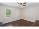 Bedroom with hardwood floors, ceiling fan, and a window with outside view at 175 Springvalley Way, Stockbridge, GA 30281