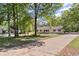 Lovely yellow house on a large lot featuring mature trees and a long private driveway at 175 Springvalley Way, Stockbridge, GA 30281