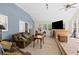The cozy living room features carpeting, a ceiling fan, and plenty of windows at 175 Springvalley Way, Stockbridge, GA 30281
