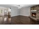 Spacious living room with hardwood floors, fireplace, and open access to the kitchen area at 175 Springvalley Way, Stockbridge, GA 30281