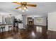 Open-concept living room with hardwood floors, a fireplace, and an adjacent kitchen area at 175 Springvalley Way, Stockbridge, GA 30281