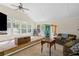 Living room featuring vaulted ceiling, ceiling fan, many windows, and a cozy seating area at 175 Springvalley Way, Stockbridge, GA 30281