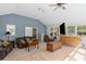 Living room features carpeting, a ceiling fan, and plenty of windows at 175 Springvalley Way, Stockbridge, GA 30281