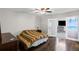 Bedroom with hardwood flooring, ceiling fan, and a sliding glass door at 175 Springvalley Way, Stockbridge, GA 30281