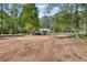 A large lot featuring mature trees and a small structure, located in a quiet wooded setting at 175 Springvalley Way, Stockbridge, GA 30281