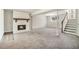 Cozy carpeted basement featuring a white brick fireplace with wooden mantle and stairs to the upper level at 4590 Cedar Ridge Trl, Stone Mountain, GA 30083