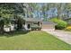 Charming split-level home with a well-manicured lawn, attached garage, and beautiful landscaping at 4590 Cedar Ridge Trl, Stone Mountain, GA 30083
