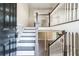 Bright foyer with staircase featuring white railing and grey painted stairs leading to upper and lower levels at 4590 Cedar Ridge Trl, Stone Mountain, GA 30083