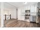 Bright kitchen with stainless steel appliances, granite countertops, and adjacent dining area with staircase at 4590 Cedar Ridge Trl, Stone Mountain, GA 30083