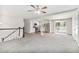 The spacious living area is adjacent to a modern kitchen and has plush carpeting and stairs to the next level at 4590 Cedar Ridge Trl, Stone Mountain, GA 30083