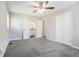 Main bedroom featuring plush carpeting, neutral walls, and a bathroom en suite with a view of the bathroom in the background at 4590 Cedar Ridge Trl, Stone Mountain, GA 30083