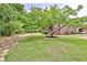 Well-manicured backyard featuring mature trees, lush lawn, and stone-lined border at 5 Northlake Cir # 4 & 5, Peachtree City, GA 30269