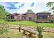 Lush backyard featuring a stone bench, rock garden and covered patio at 5 Northlake Cir # 4 & 5, Peachtree City, GA 30269