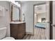 Modern bathroom with wood vanity, chrome fixtures and view to tiled shower at 5 Northlake Cir # 4 & 5, Peachtree City, GA 30269