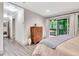 View of primary bedroom featuring hardwood flooring, slider to deck, and ensuite bathroom entrance at 5 Northlake Cir # 4 & 5, Peachtree City, GA 30269