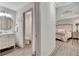 Hallway view of primary bedroom with ensuite bathroom, neutral walls, and hardwood flooring at 5 Northlake Cir # 4 & 5, Peachtree City, GA 30269