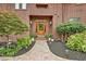 Charming front entrance with wood door, brick walkway, and beautiful landscaping at 5 Northlake Cir # 4 & 5, Peachtree City, GA 30269