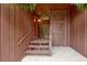 Inviting covered front porch with lattice design, wooden steps, and a bright red door at 5 Northlake Cir # 4 & 5, Peachtree City, GA 30269