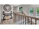 Hallway with decorative clock, staircase with wooden railing and view of outdoors at 5 Northlake Cir # 4 & 5, Peachtree City, GA 30269