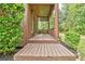 Cozy, covered porch with privacy lattice, outdoor seating, and attractive landscaping at 5 Northlake Cir # 4 & 5, Peachtree City, GA 30269