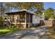 Landscaped backyard featuring a charming screened-in porch and driveway at 3120 Church St, Atlanta, GA 30344