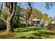Expansive backyard featuring a lush lawn, mature trees, and a charming screened porch at 3120 Church St, Atlanta, GA 30344