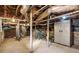 Unfinished basement space with exposed ductwork, support beams, and a storage cabinet at 3120 Church St, Atlanta, GA 30344